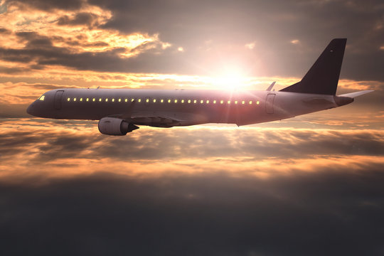 Airplane flying at sunrise