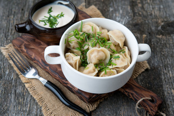 Boiled sour cream and greens pelmeni
