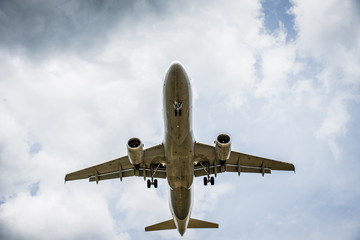 Airplane flying with clouds in background