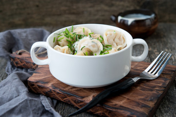 Boiled sour cream and greens pelmeni
