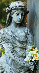 Statue of woman on tomb as a symbol of depression and sorrow (Ly