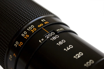 Detail of the old zoom lens on a camera, white background
