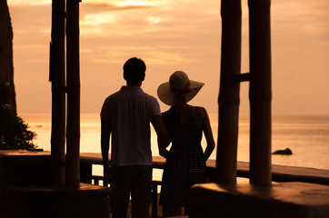 Couple enjoying the sunset in a exotic island hotel setting.     © kieferpix
