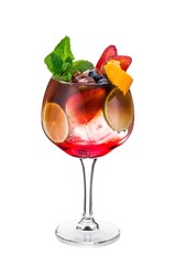 The glass with espresso tonic decorated with lime, strawberry, blueberry, ice, mint leaves and orange peel