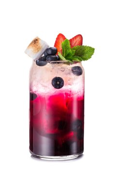 Lemonade in transparent mug with ice, blueberry, strawberry, mint leaves and toasted marshmallows