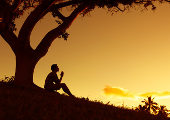 Man praying, meditating in harmony and peace at sunset

 - obrazy, fototapety, plakaty