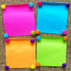 colorful sticky notes on cork bulletin board