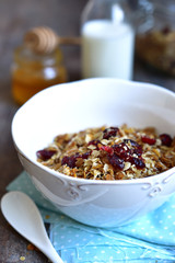 Homemade granola in a white bowl for a breakfast.
