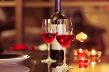 Romantic fine dinning. Glass of red wine in a restaurant setting.