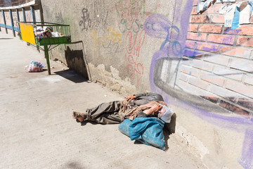 Homeless barefoot lying sleeping street, la Paz, Bolivia.