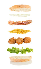  floating sandwich, meat ball sandwich with lettuce, chips, bacon and onions