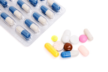 Medicine pills and capsules on a white background