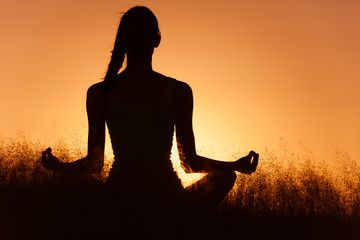 Fototapeta premium Healthy mind body spirt. Woman doing Yoga outdoors. 