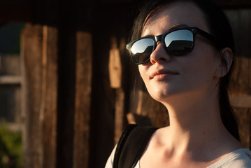 beautiful young girl dressed in a white t-shirt and sunglasses