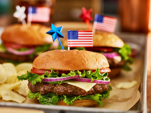 cheesebuergers in tray with potato chips patriotic american theme