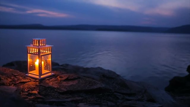 candle flame shines on the lake