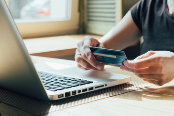 girl makes a purchase on the Internet on the computer with credit card