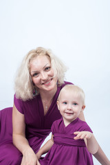 Blonde woman with a small daughter in matching dresses