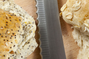 Close up of two sliced seeded bread rolls