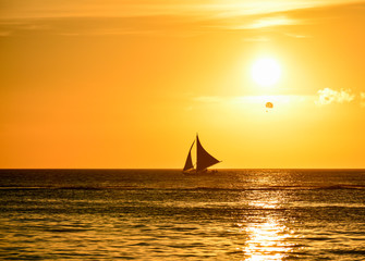 Fototapeta na wymiar Sunset in Boracay, Philippines with a boat in foreground