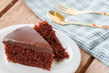 Delicious chocolate cake on plate on table 