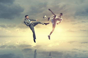 Fototapeta na wymiar Businessman kicking ball