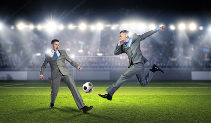 Two businessmen fight for ball