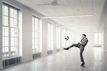 Fototapeta na wymiar Playing football in office
