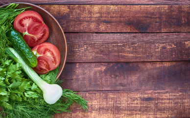 Tomato and cucumber in a clay plate