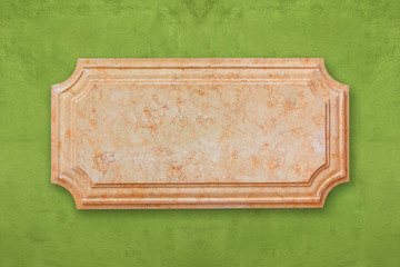 Blank signboard marble on green wall.