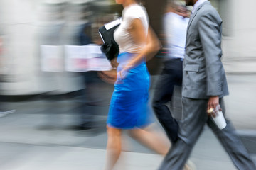 motion blurred business people walking on the street