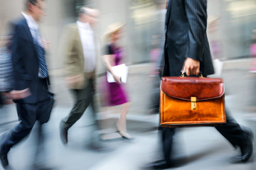 motion blurred business people walking on the street