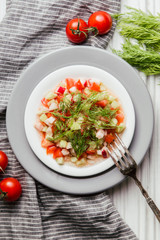 Salad of cucumber, tomato, dill and olive oil