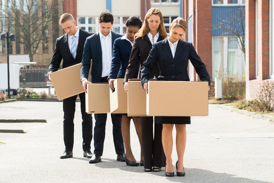 Unemployed Businesspeople With Cardboard Boxes