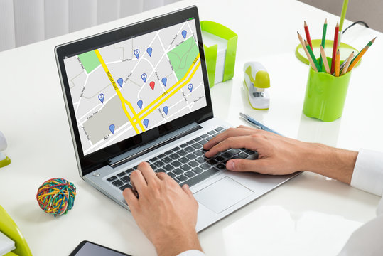 Person Using GPS Map On Laptop