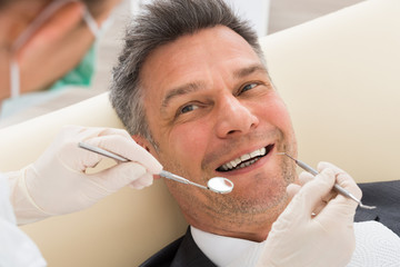 Man Having Dental Check-up In Clinic