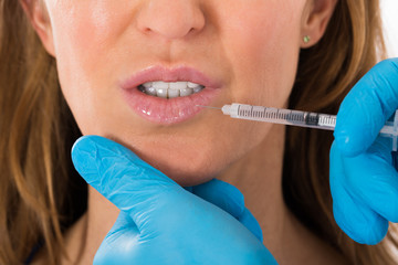 Woman Receive Cosmetic Injection On Lip