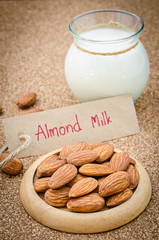 Almond and almond milk in glass.