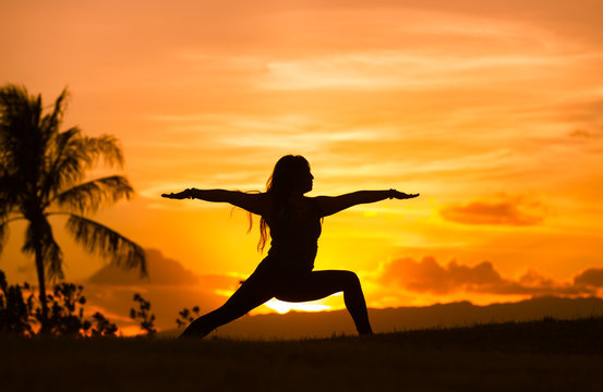 Body balance and fitness concept. Woman doing yoga outdoors in a beautiful setting.