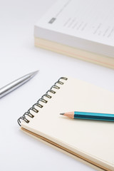 Blank notebook with pencil on white background