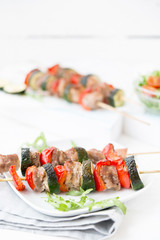 Homemade meat shish kebab with vegetables on skewers
