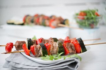 Homemade meat shish kebab with vegetables on skewers
