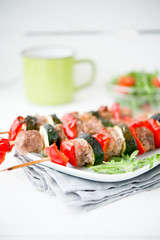 Homemade meat shish kebab with vegetables on skewers
