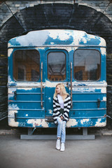 girl with a book at graffiti and subway train