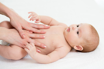Fototapeta na wymiar Baby massage. Mom massaging child belly. Treatment of colic