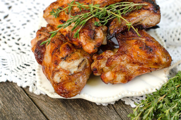 Chicken wings fried with thyme on a plate