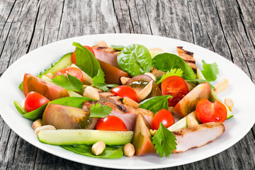 Grilled pork chops salad with vegetables and spinach