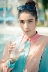 pretty smiling girl with iced latte in sunny city
