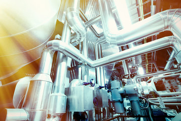 Equipment, cables and piping as found inside of a modern industr