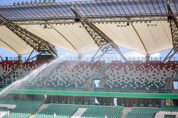 Fototapeta premium Watering grass on big sport stadium